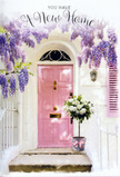 This scene shows a beautifully styled doorway that could easily belong to a tucked-away New Barnet terrace near the calm streets leading towards High Barnet. The front door, painted in a gentle, dusky pink, glows softly as sunlight brushes across its panels, making the colour seem almost velvety. Overhead, lengthening garlands of wisteria tumble down in loose cascades, each bloom a mix of lavender, lilac, and muted violet, creating a fragrant canopy that frames the entrance like a natural arch. The surrounding wall is whitewashed, slightly textured, and quietly reflective, catching soft shadows from the wisteria leaves and blossoms. A single shutter, in a matching pastel pink, leans towards the light, tying the entire colour palette together in a harmony of blush, cream, and green. Resting on the doorstep is a vintage-style grey bucket, carefully filled with a lush selection of white and cream roses. The roses look freshly arranged, their petals plump and velvety, some cupping inwards, others fully unfurled to reveal creamy hearts. Gentle sprigs of green foliage weave between the blooms, adding depth and a hint of wild garden charm. Around the bucket, a pale pink ribbon is tied in a soft bow, its satin strands trailing gracefully onto the stone step, echoing the door's warmth. The atmosphere feels intimate and hopeful, as though the flowers have just been delivered to celebrate someone's first day in their New Barnet home. It's an image of quiet joy and welcome, where every petal and painted surface collaborates to whisper, "You're home now."